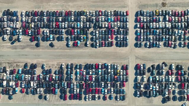 Used damaged cars on auction reseller company big parking lot ready for resale services. Sales of secondhand vehicles for rebuilt or salvage title