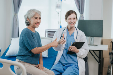 Beautiful modern female doctor talking to an elderly woman patient with a smiling face at the hospital.