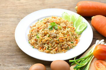 Fried rice with pork and egg  on wooden table.