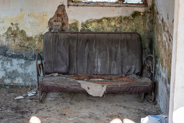 The old chair is broken and dusty