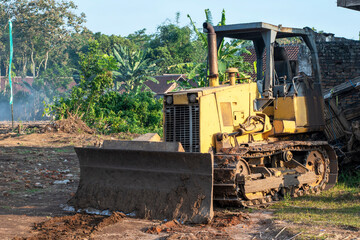 Bulldozer at land clearing construction site