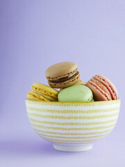 colorful macaroons isolated on violet background