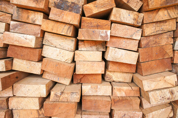 Obraz premium Stacking of processed wood logs in daytime