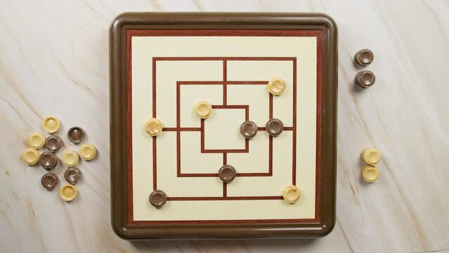 People Playing Nine Men Morris Board Game