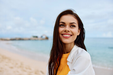 Portrait of a happy woman smile with teeth with long hair brunette summer travel and feeling of freedom, balance