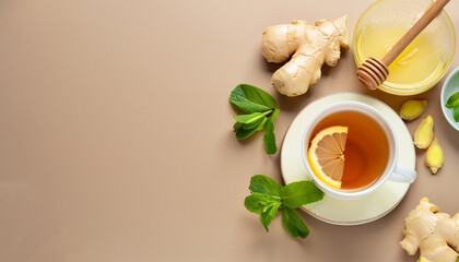 Ginger tea. Cup of ginger tea with lemon, honey and mint on beige background. Concept alternative...