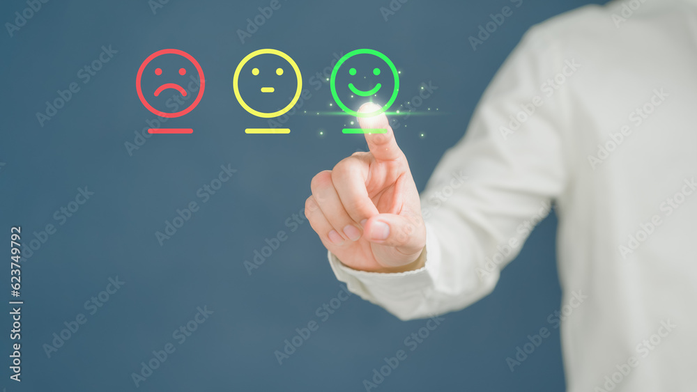 Poster customer's hand is touching virtual screen on the happy smile face icon to give satisfaction in serv