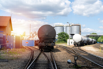Railroad tank cars near oil refinery. Railway train wagon to transport liquid and gaseous...