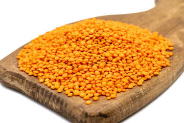 Red lentils isolated on white background. Raw red lentil on wood serving board. Close up