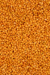 Pile of red lentils as background, legume as background. close-up of raw red lentils. Top view