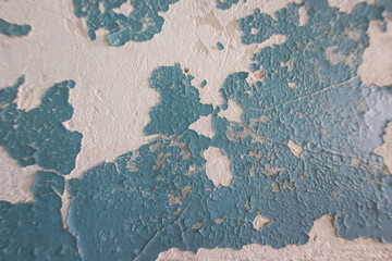 Old dry surface in the cracks. Piece of the pattern, a background or wallpaper for your desktop. Cracked blue paint on surface. Peeling paint rough texture.