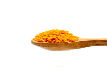 Red lentils on wooden spoon. Pile of Red lentils isolated on white background. close up