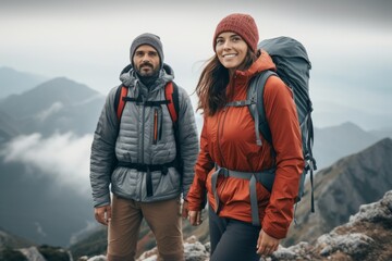 Obraz na płótnie Canvas a girl and a man in mountain gear on top of a mountain. travel concept. generative ai.