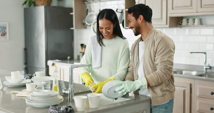 Couple, talking and kitchen sink for washing dishes together, helping hand or happy chat in home with joke. Man, woman and teamwork for bacteria, cleaning or smile for comic conversation in apartment