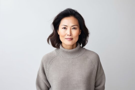 Portrait of a smiling middle-aged asian woman in sweater