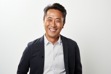 Portrait of a happy mature asian businessman smiling at camera.