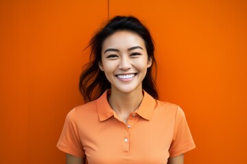 Portrait photography of a pleased Chinese woman in her 20s wearing a sporty polo shirt against an abstract background 