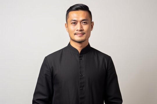 Portrait of a young handsome asian man wearing a black shirt