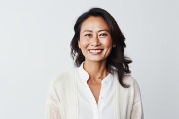 Fototapeta premium Portrait of a smiling woman looking at the camera over white background
