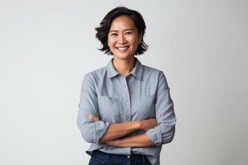 Portrait photography of a satisfied Indonesian woman in her 40s wearing a cool cap or hat against a white background  - obrazy, fototapety, plakaty