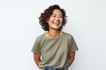 Portrait photography of a happy Indonesian woman in her 40s wearing knee-length shorts against a white background 