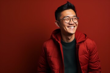 Fototapeta premium Portrait photography of a happy Chinese man in his 30s wearing a chic cardigan against an abstract background 