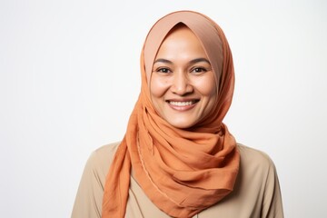 Portrait of muslim woman with hijab smiling at camera over white background