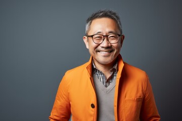 Obraz premium Portrait photography of a pleased Chinese man in his 40s wearing a chic cardigan against an abstract background 