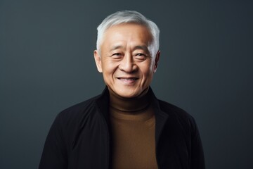 Obraz premium Portrait photography of a satisfied Chinese man in his 70s wearing a chic cardigan against an abstract background 