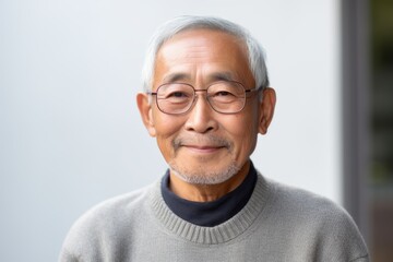 Fototapeta premium asian senior man with eyeglasses and grey sweater at home