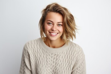 Fototapeta premium Portrait of a beautiful young woman with blond hair smiling against white background
