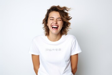 Fototapeta premium Portrait of a happy young woman laughing isolated on a white background