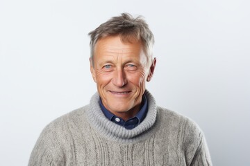 Obraz premium Portrait of a happy senior man with grey hair against white background