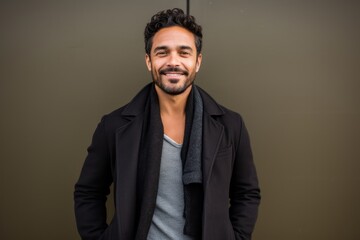 Obraz premium Portrait of a handsome young man with coat smiling at the camera