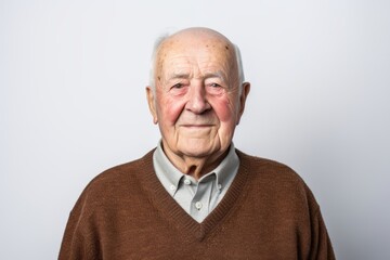 Obraz premium Portrait of a senior man in a brown sweater on a white background