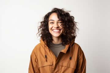 Portrait photography of a pleased Brazilian woman in her 20s wearing a warm parka against a white background 