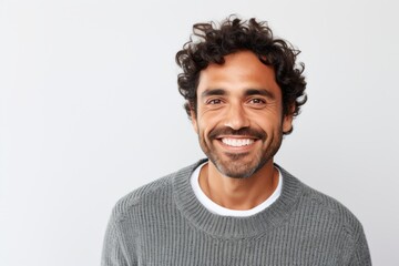 Close up portrait of a handsome young man smiling and looking at camera over white background