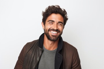 Fototapeta premium Portrait of a handsome young man laughing isolated on a white background