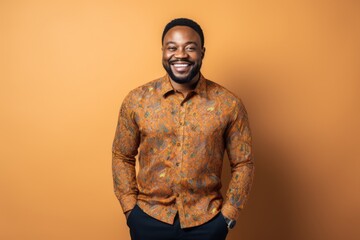 Portrait photography of a pleased Nigerian black man in his 30s wearing a chic cardigan against an abstract background 