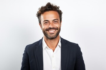 Portrait of a handsome young man smiling at the camera while standing against white background