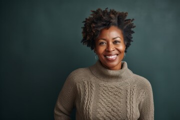 Fototapeta na wymiar Portrait of smiling african american woman standing against chalkboard