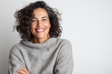 Fototapeta premium Portrait of a beautiful young woman smiling at the camera isolated on a white background