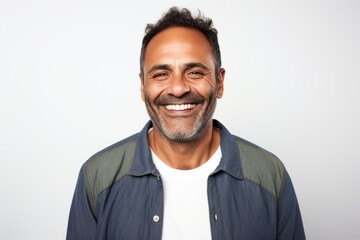 Portrait of a smiling middle-aged Indian man against white background