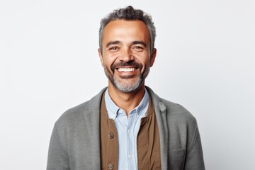 Portrait of handsome middle-aged man smiling at camera while standing against white background