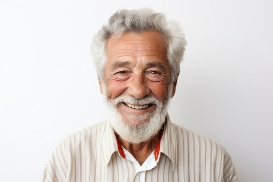 Portrait of happy senior man smiling at camera while standing against white background