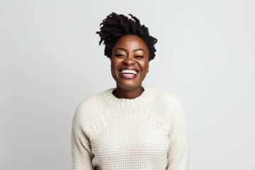 Obraz premium Portrait of a happy african american woman laughing against white background