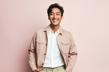 Portrait of a smiling young asian man in beige jacket