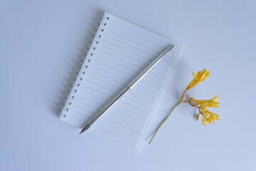 notebook and pen with flowers