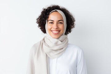 Portrait of smiling african american woman in hijab on white background