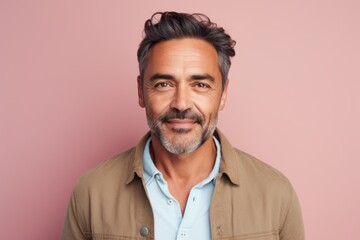 Obraz premium Portrait of a handsome middle-aged man in casual clothes on a pink background